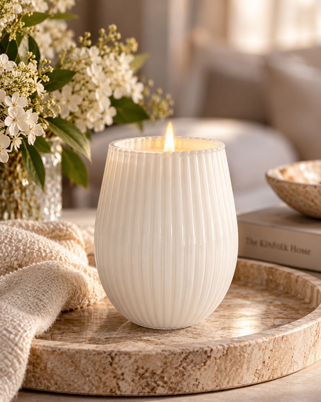 Ivory ribbed 400g soy candle styled on a travertine tray